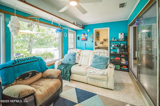 723 Montego Rd W, Jacksonville, FL 32216 - living area with speckle patterned floor and ceiling fan