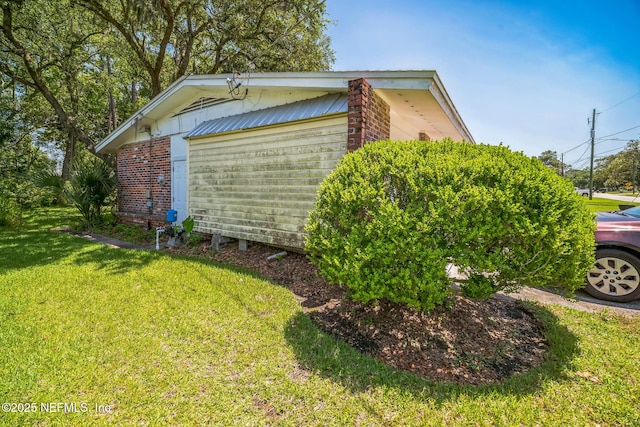 723 Montego Rd W, Jacksonville, FL 32216 - view of side of home featuring a lawn and brick siding