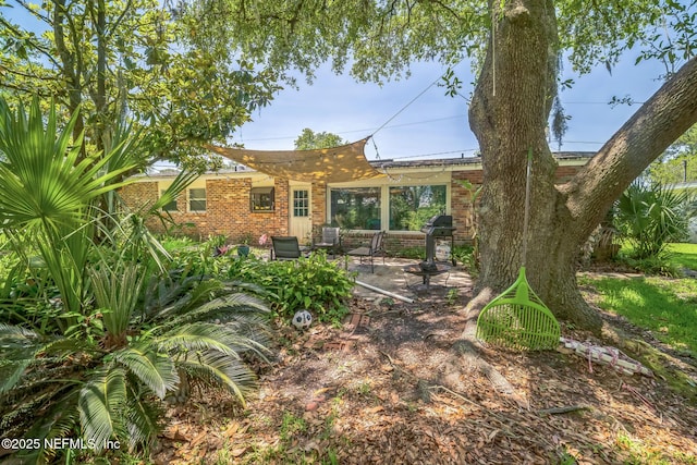 723 Montego Rd W, Jacksonville, FL 32216 - rear view of house featuring a patio and brick siding