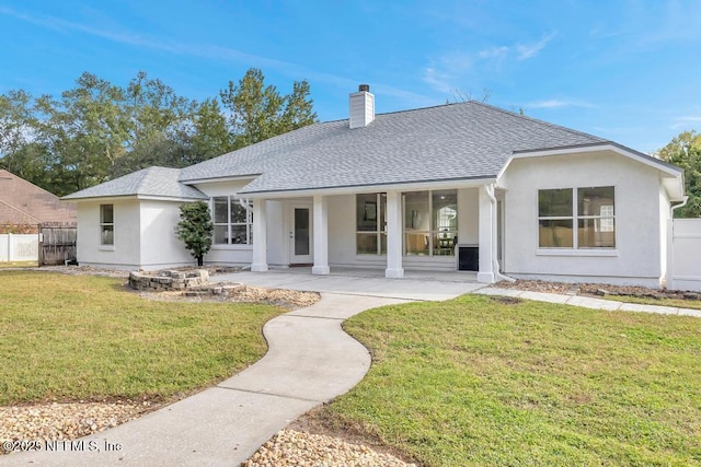 4833 Saddlehorn Trl, Middleburg, FL 32068 - back of house featuring a shingled roof, a chimney, stucco siding, and a patio area