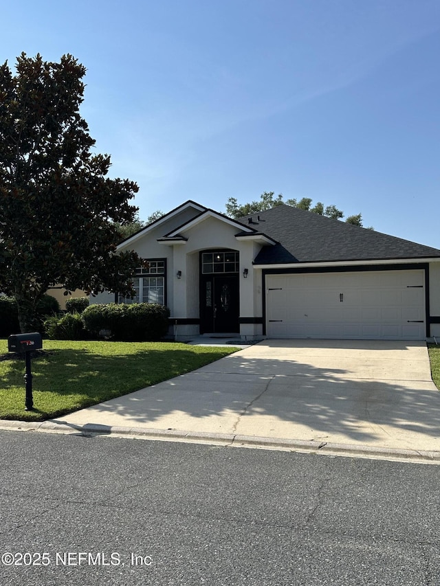 1456 Greenway Pl, Fleming Island, FL 32003 - ranch-style home with a garage, driveway, a front yard, and stucco siding