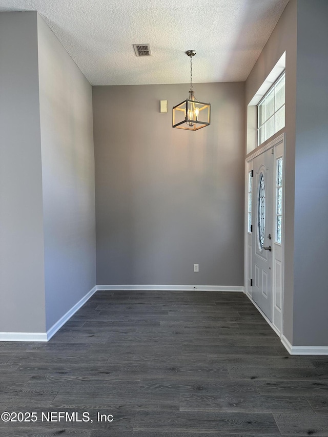 1456 Greenway Pl, Fleming Island, FL 32003 - entryway with a textured ceiling, a chandelier, dark wood-type flooring, and baseboards