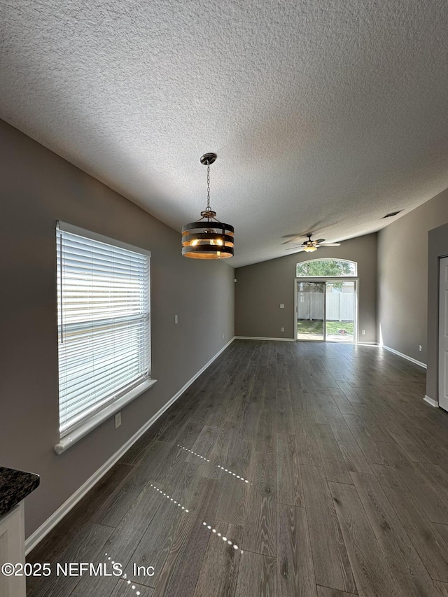 1456 Greenway Pl, Fleming Island, FL 32003 - empty room with dark wood-style flooring, a textured ceiling, a ceiling fan, and baseboards