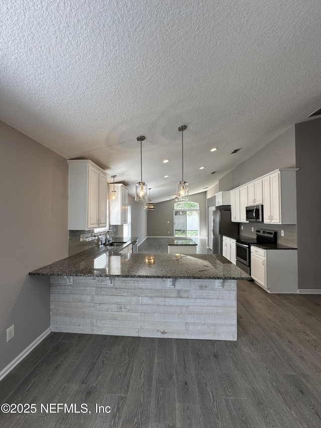 1456 Greenway Pl, Fleming Island, FL 32003 - kitchen featuring appliances with stainless steel finishes, a sink, dark wood-type flooring, a textured ceiling, and white cabinetry