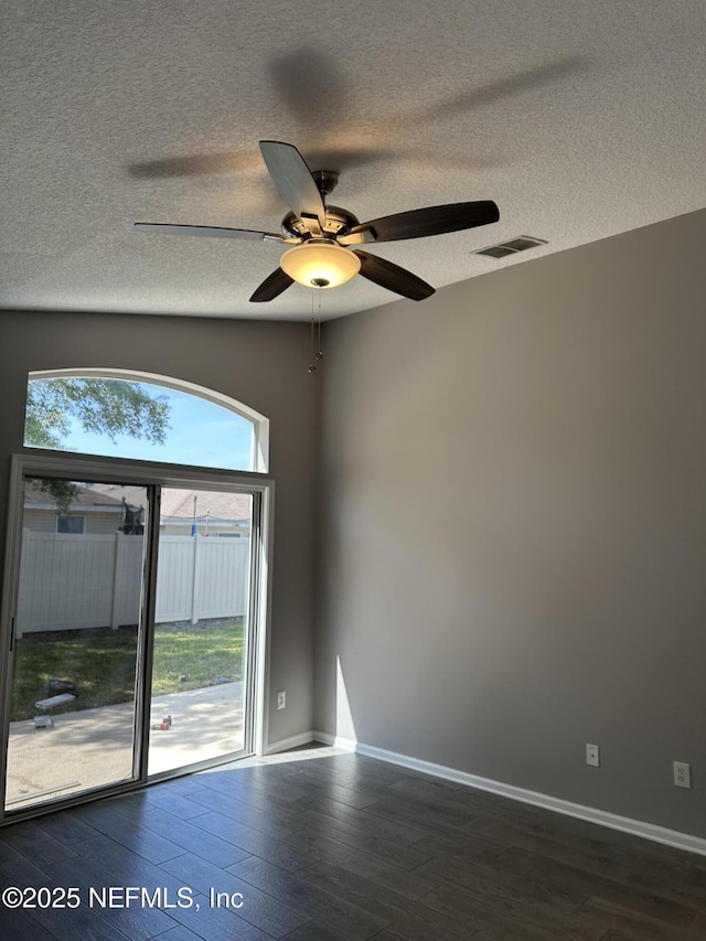 1456 Greenway Pl, Fleming Island, FL 32003 - empty room featuring a textured ceiling, dark wood-style floors, a ceiling fan, and baseboards