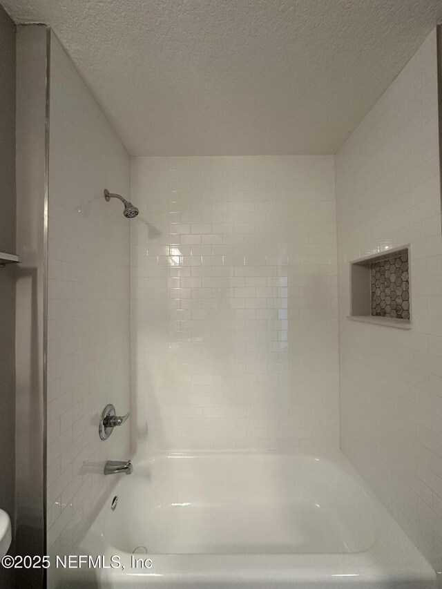 1456 Greenway Pl, Fleming Island, FL 32003 - full bathroom featuring a textured ceiling, washtub / shower combination, and toilet