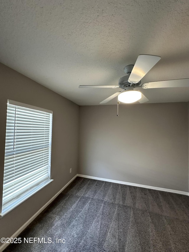 1456 Greenway Pl, Fleming Island, FL 32003 - spare room with dark colored carpet, a ceiling fan, baseboards, and a textured ceiling