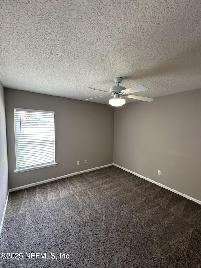 1456 Greenway Pl, Fleming Island, FL 32003 - spare room with dark colored carpet, ceiling fan, baseboards, and a textured ceiling
