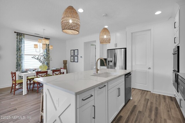 44 Sea Grn Way, Ponte Vedra, FL 32081 - kitchen featuring a sink, appliances with stainless steel finishes, a kitchen island with sink, light wood finished floors, and recessed lighting