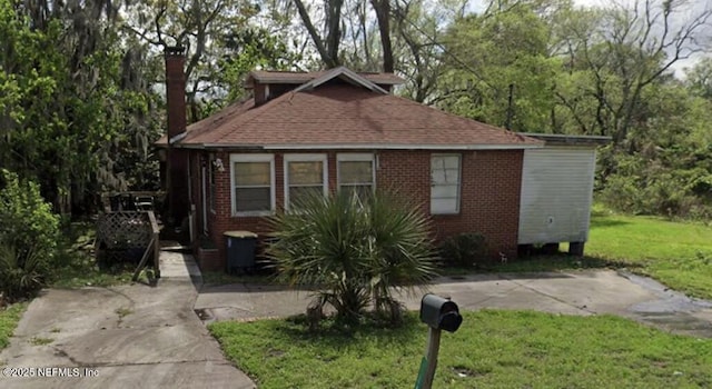 2842 Edison Ave, Jacksonville, FL 32254 - bungalow-style home with a front yard, brick siding, and a shingled roof
