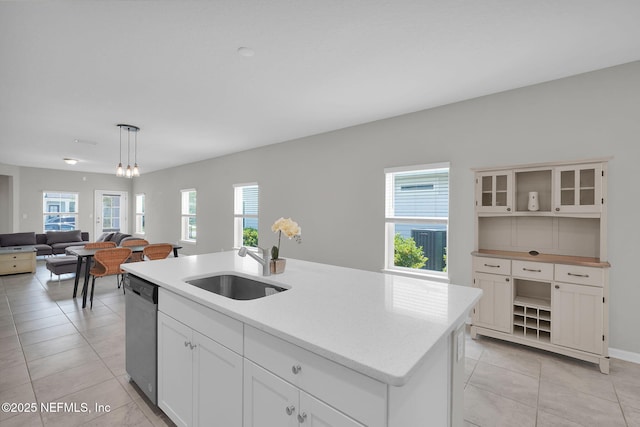 328 Clarys Run, Saint Augustine, FL 32092 - kitchen featuring dishwasher, open shelves, a sink, light tile patterned flooring, and a center island with sink