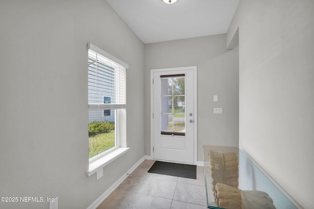 328 Clarys Run, Saint Augustine, FL 32092 - doorway to outside featuring healthy amount of natural light, tile patterned flooring, and baseboards