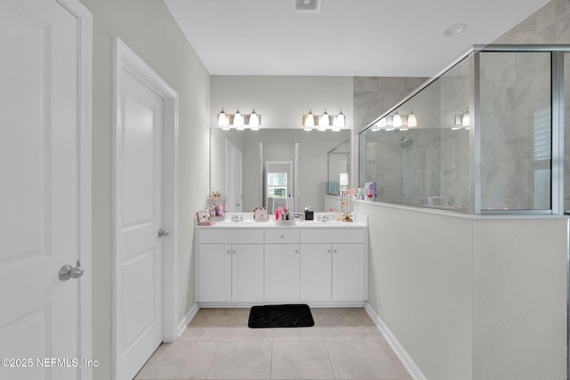328 Clarys Run, Saint Augustine, FL 32092 - bathroom featuring tiled shower, double vanity, tile patterned floors, and baseboards