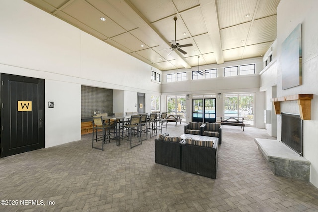 328 Clarys Run, Saint Augustine, FL 32092 - living room featuring a high ceiling, a ceiling fan, a fireplace with raised hearth, and recessed lighting