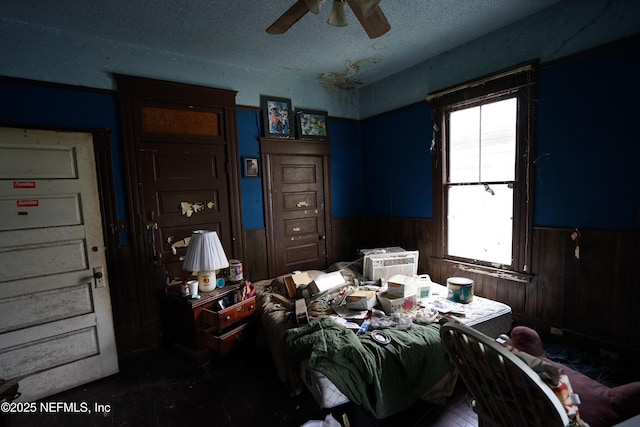 223 E 6th St, Jacksonville, FL 32206 - bedroom with multiple windows, wainscoting, a textured ceiling, wood walls, and ceiling fan