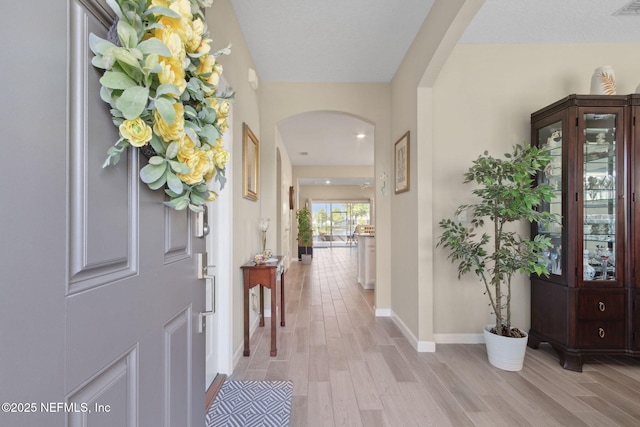 267 Ash Breeze Cv, Saint Augustine, FL 32095 - foyer with arched walkways, light wood finished floors, and baseboards
