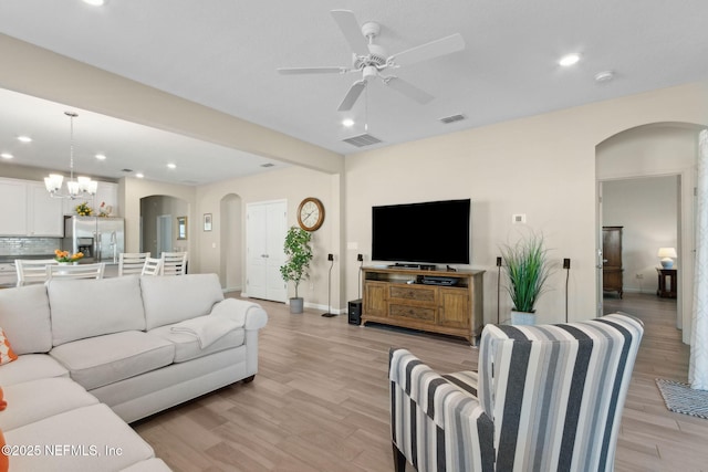 267 Ash Breeze Cv, Saint Augustine, FL 32095 - living room with arched walkways, ceiling fan, light wood-style floors, recessed lighting, and baseboards