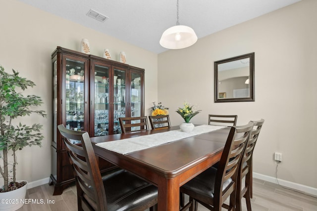 267 Ash Breeze Cv, Saint Augustine, FL 32095 - dining area with baseboards and light wood-type flooring