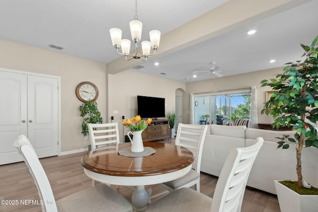 267 Ash Breeze Cv, Saint Augustine, FL 32095 - dining space with light wood-style floors, arched walkways, a chandelier, recessed lighting, and a ceiling fan