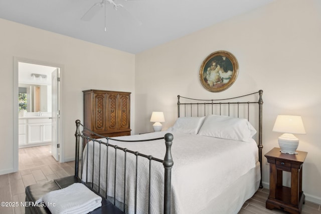 267 Ash Breeze Cv, Saint Augustine, FL 32095 - bedroom featuring wood finish floors, connected bathroom, baseboards, a ceiling fan, and a sink