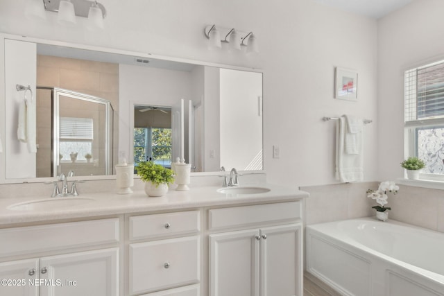 267 Ash Breeze Cv, Saint Augustine, FL 32095 - bathroom featuring a shower stall, a garden tub, double vanity, and a ceiling fan
