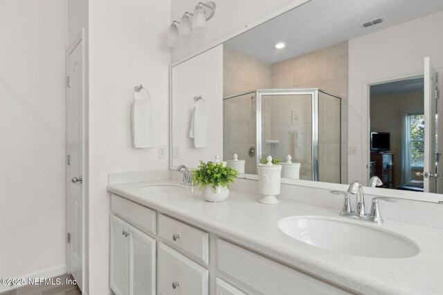 267 Ash Breeze Cv, Saint Augustine, FL 32095 - bathroom featuring double vanity, a stall shower, and ensuite bathroom