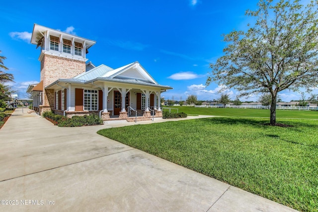 267 Ash Breeze Cv, Saint Augustine, FL 32095 - view of front of home with covered porch, a front yard, and brick siding