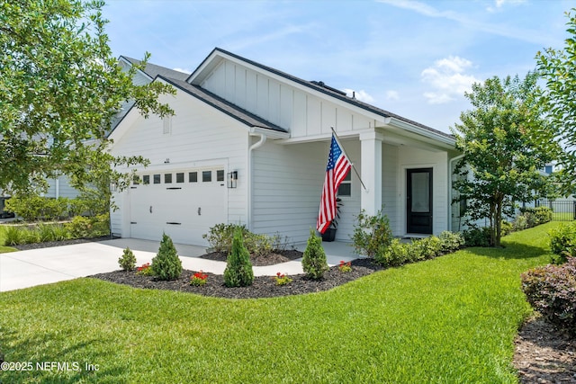 32 Mosaic Park Ave, Saint Augustine, FL 32092 - view of front of property with board and batten siding, a garage, concrete driveway, and a front yard