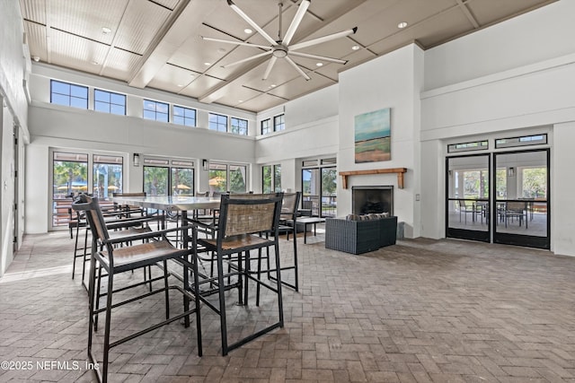 32 Mosaic Park Ave, Saint Augustine, FL 32092 - dining room featuring a towering ceiling, brick floors, recessed lighting, and a fireplace