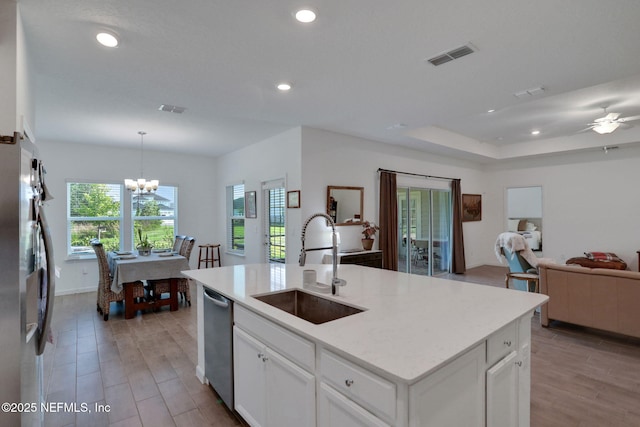 84754 Fall River Pkwy, Fernandina Beach, FL 32034 - kitchen featuring a sink, stainless steel appliances, open floor plan, recessed lighting, and white cabinetry