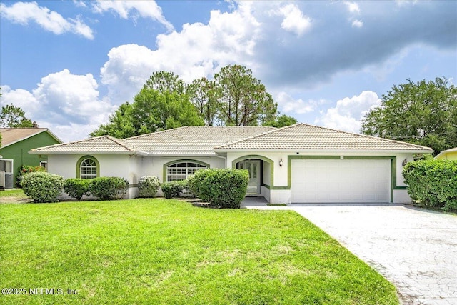 30 Patuxent Ln, Palm Coast, FL 32164 - view of front of home featuring a garage, a front lawn, stucco siding, and a tile roof