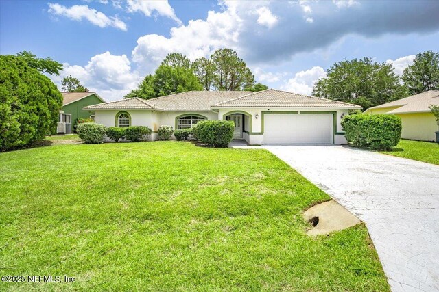 30 Patuxent Ln, Palm Coast, FL 32164 - view of front of property with an attached garage, stucco siding, driveway, a tile roof, and a front lawn