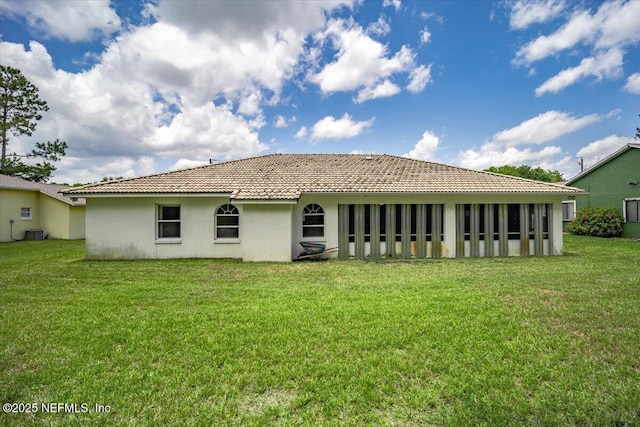 30 Patuxent Ln, Palm Coast, FL 32164 - rear view of property with a tiled roof, stucco siding, a lawn, and central AC unit