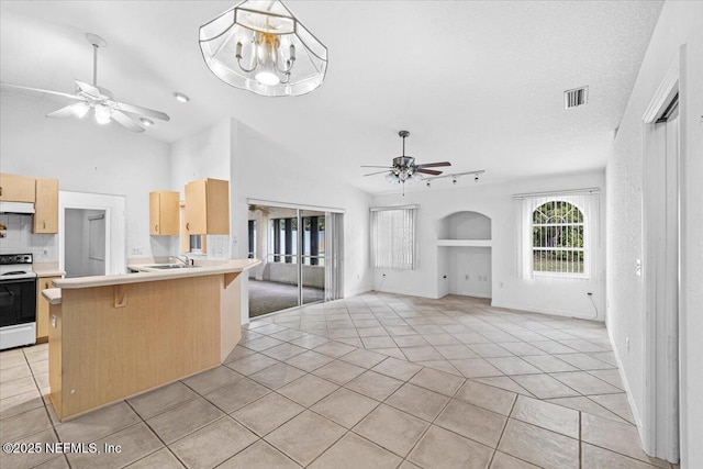 30 Patuxent Ln, Palm Coast, FL 32164 - kitchen with white range with electric stovetop, a ceiling fan, light tile patterned floors, light brown cabinets, and arched walkways