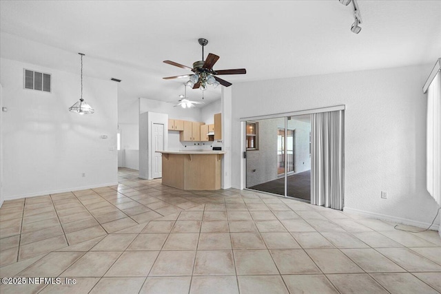 30 Patuxent Ln, Palm Coast, FL 32164 - unfurnished living room with a ceiling fan, lofted ceiling, light tile patterned floors, baseboards, and track lighting
