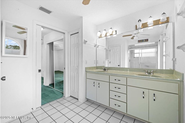 30 Patuxent Ln, Palm Coast, FL 32164 - full bathroom featuring double vanity, a ceiling fan, a shower stall, healthy amount of natural light, and a textured ceiling