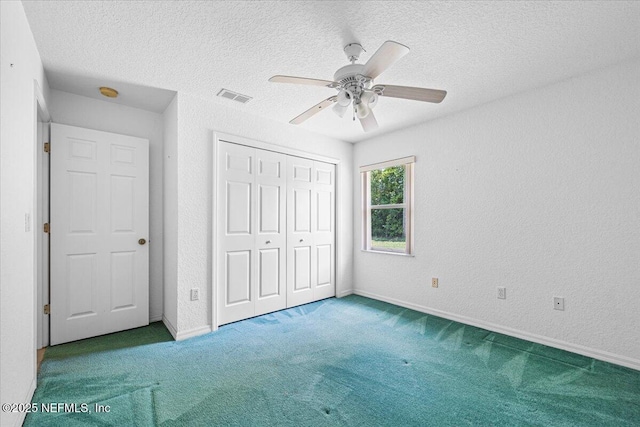 30 Patuxent Ln, Palm Coast, FL 32164 - unfurnished bedroom with carpet flooring, a closet, a textured ceiling, a ceiling fan, and baseboards