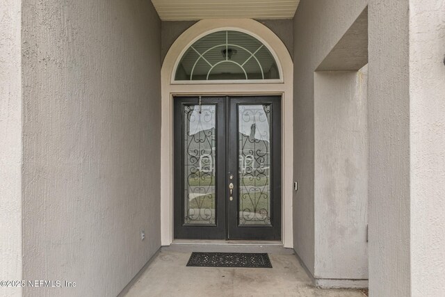 1098 Spanish Bay Ct, Orange Park, FL 32065 - property entrance with french doors and stucco siding
