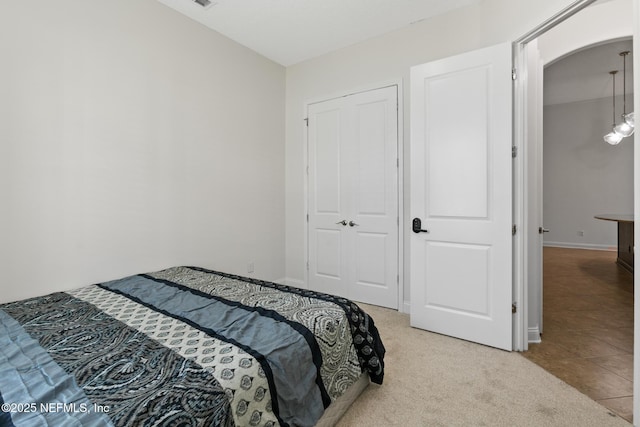 1098 Spanish Bay Ct, Orange Park, FL 32065 - bedroom with arched walkways, a closet, and light tile patterned flooring