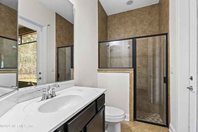 1098 Spanish Bay Ct, Orange Park, FL 32065 - bathroom with toilet, vanity, a shower stall, tile patterned floors, and a textured ceiling
