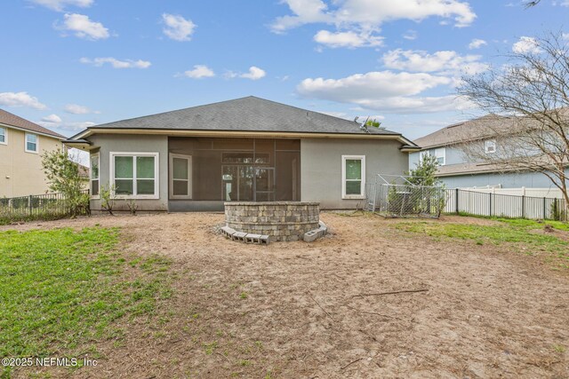 1098 Spanish Bay Ct, Orange Park, FL 32065 - rear view of property with a fenced backyard, a sunroom, stucco siding, and roof with shingles