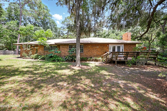 7704 Clover Ln, Keystone Heights, FL 32656 - rear view of house with french doors, a chimney, a deck, and brick siding