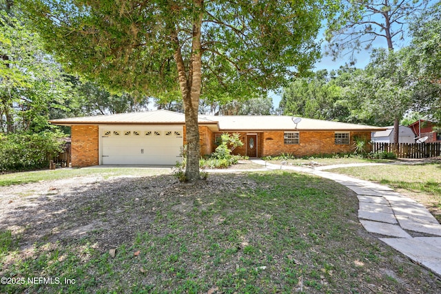 7704 Clover Ln, Keystone Heights, FL 32656 - view of front facade with an attached garage, brick siding, and driveway