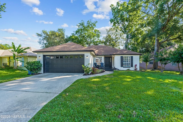 12489 Windy Willows Dr N, Jacksonville, FL 32225 - single story home with a garage, driveway, a front yard, and stucco siding