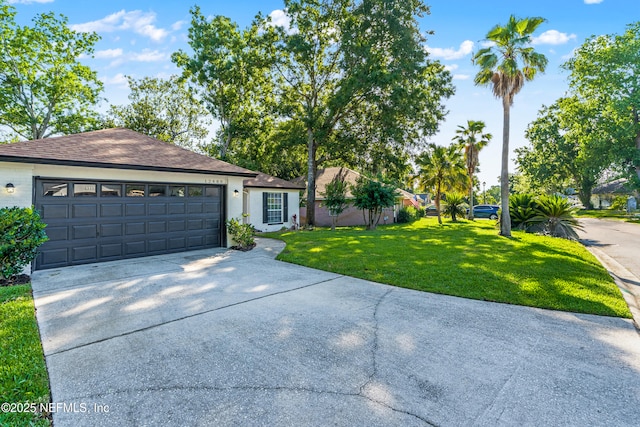 12489 Windy Willows Dr N, Jacksonville, FL 32225 - ranch-style house with a front lawn, concrete driveway, and an attached garage