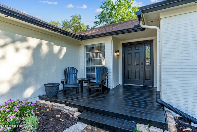 12489 Windy Willows Dr N, Jacksonville, FL 32225 - view of exterior entry with brick siding and a deck