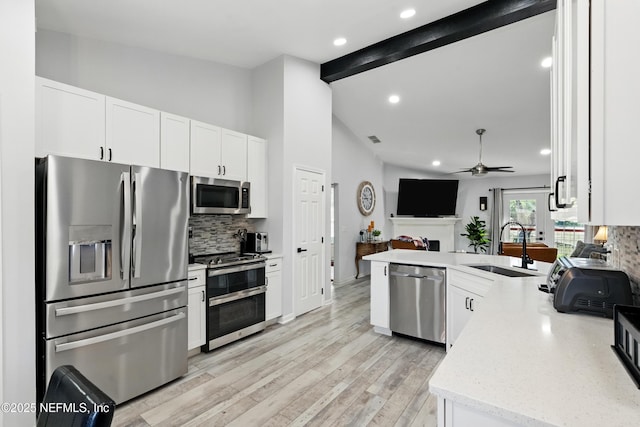 12489 Windy Willows Dr N, Jacksonville, FL 32225 - kitchen featuring stainless steel appliances, decorative backsplash, a ceiling fan, open floor plan, and recessed lighting