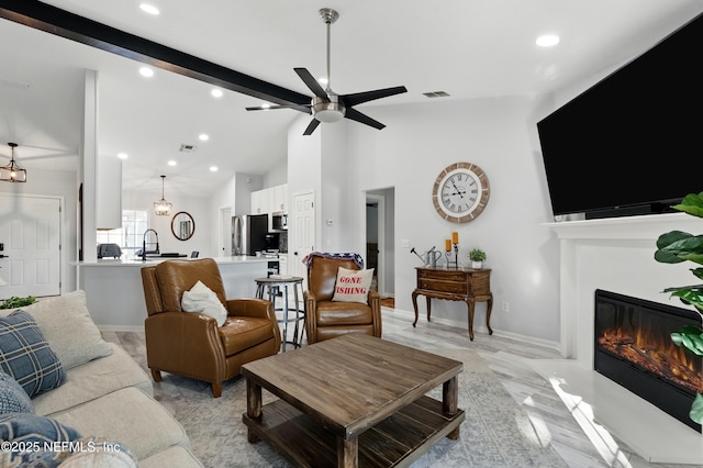 12489 Windy Willows Dr N, Jacksonville, FL 32225 - living room featuring ceiling fan, a glass covered fireplace, recessed lighting, and baseboards