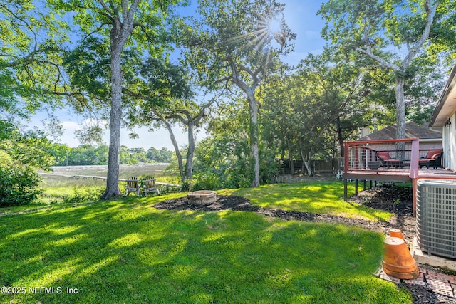 12489 Windy Willows Dr N, Jacksonville, FL 32225 - view of yard featuring a fire pit, a wooden deck, and cooling unit