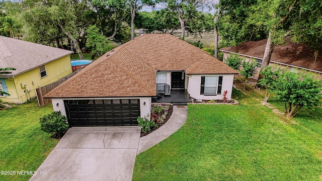 12489 Windy Willows Dr N, Jacksonville, FL 32225 - view of front facade with roof with shingles, driveway, a garage, and a front yard